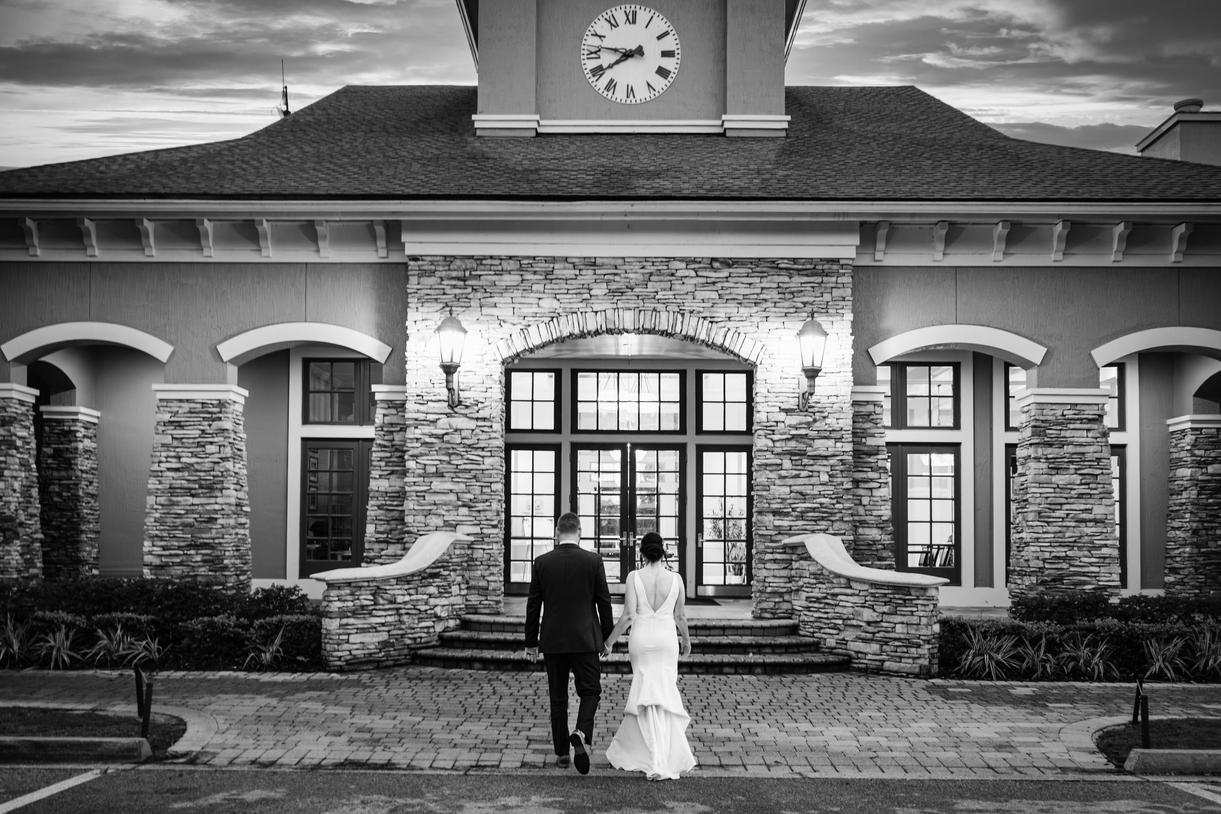 Wedding venue exterior with stone facade and dramatic sky.