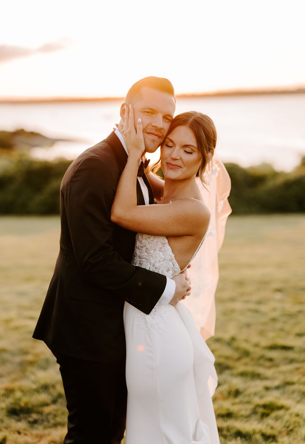 Candid wedding photos capturing emotional embraces between newlyweds in a golden field.