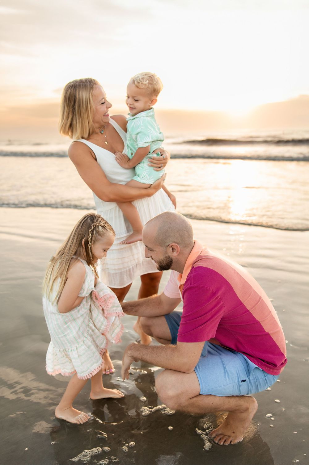 Children playing on St. Augustine Beach during sunset family photo session