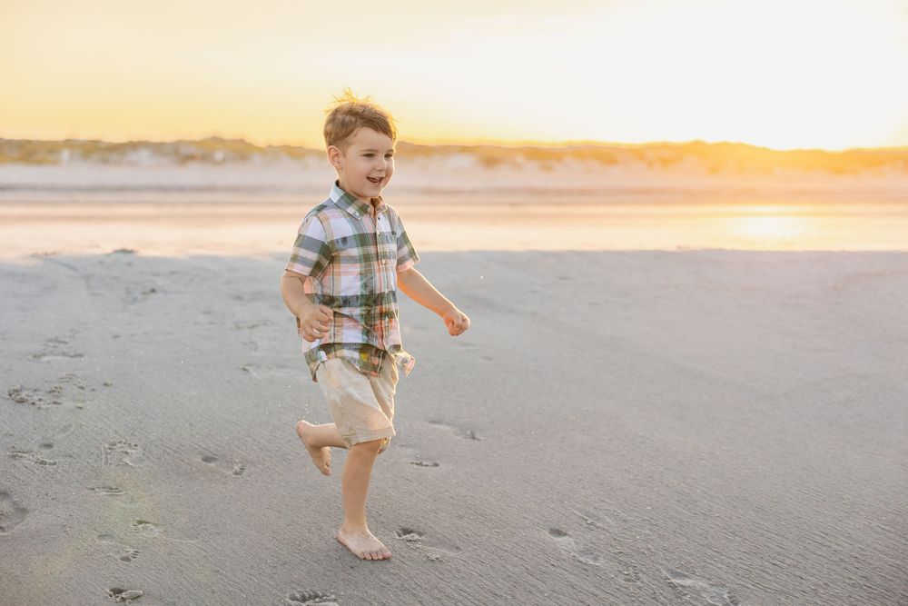 St. Augustine family photographer capturing sunset family portraits on the beach in saint augustine