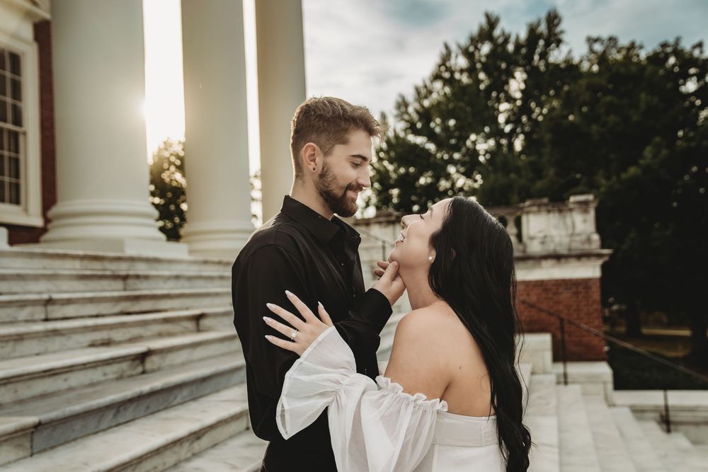 A bride and groom share an intimate moment on a grand staircase during their wedding day.