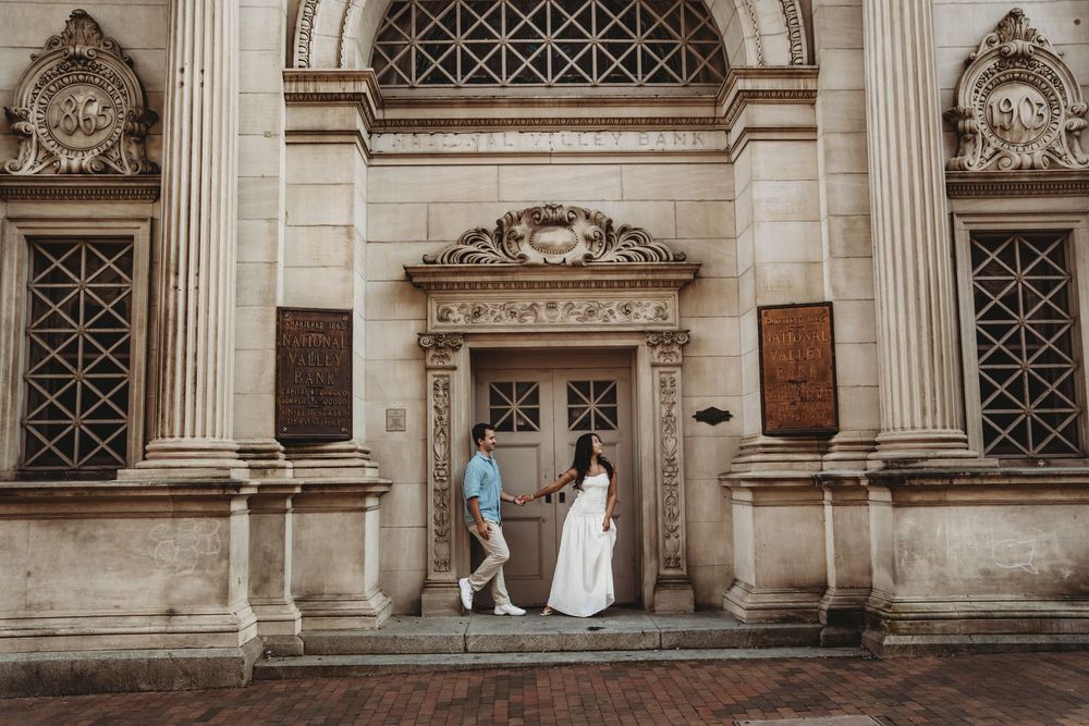 Classical stone building facade with ornate architectural details, columns, and decorative latticed windows.