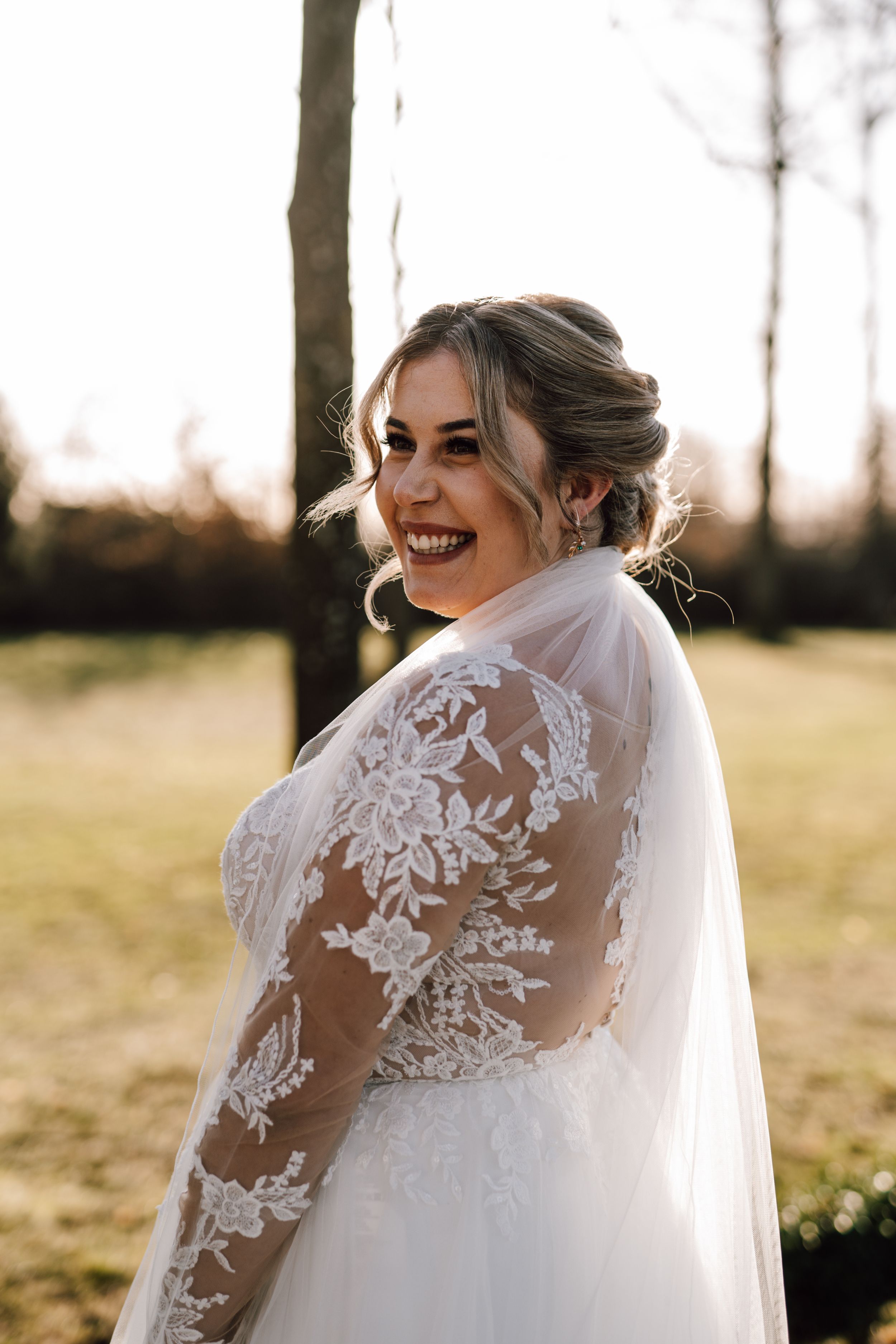 Beautiful lace wedding dress details with sheer back and floral appliques.