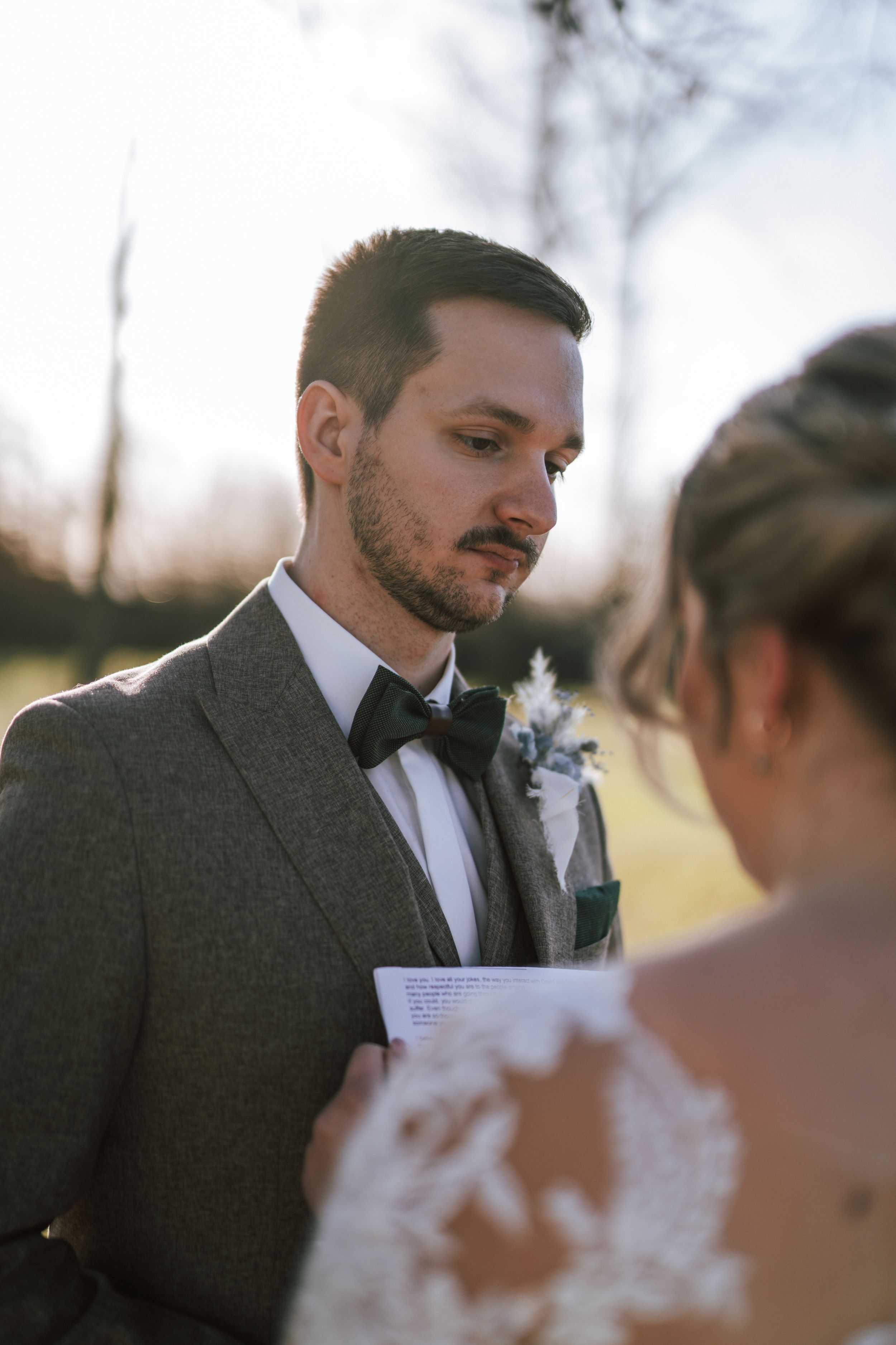 A couple exchanges vows during a romantic outdoor winter ceremony.
