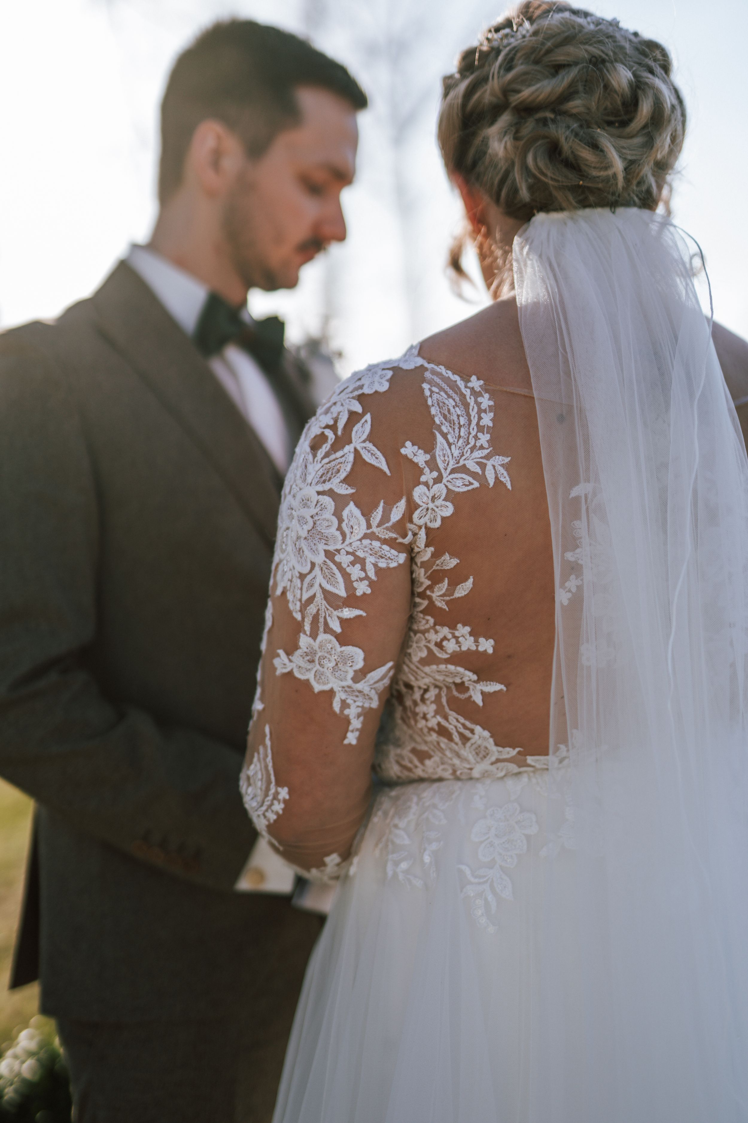 Beautiful lace detail on a wedding dress back with sheer illusion and floral appliques.