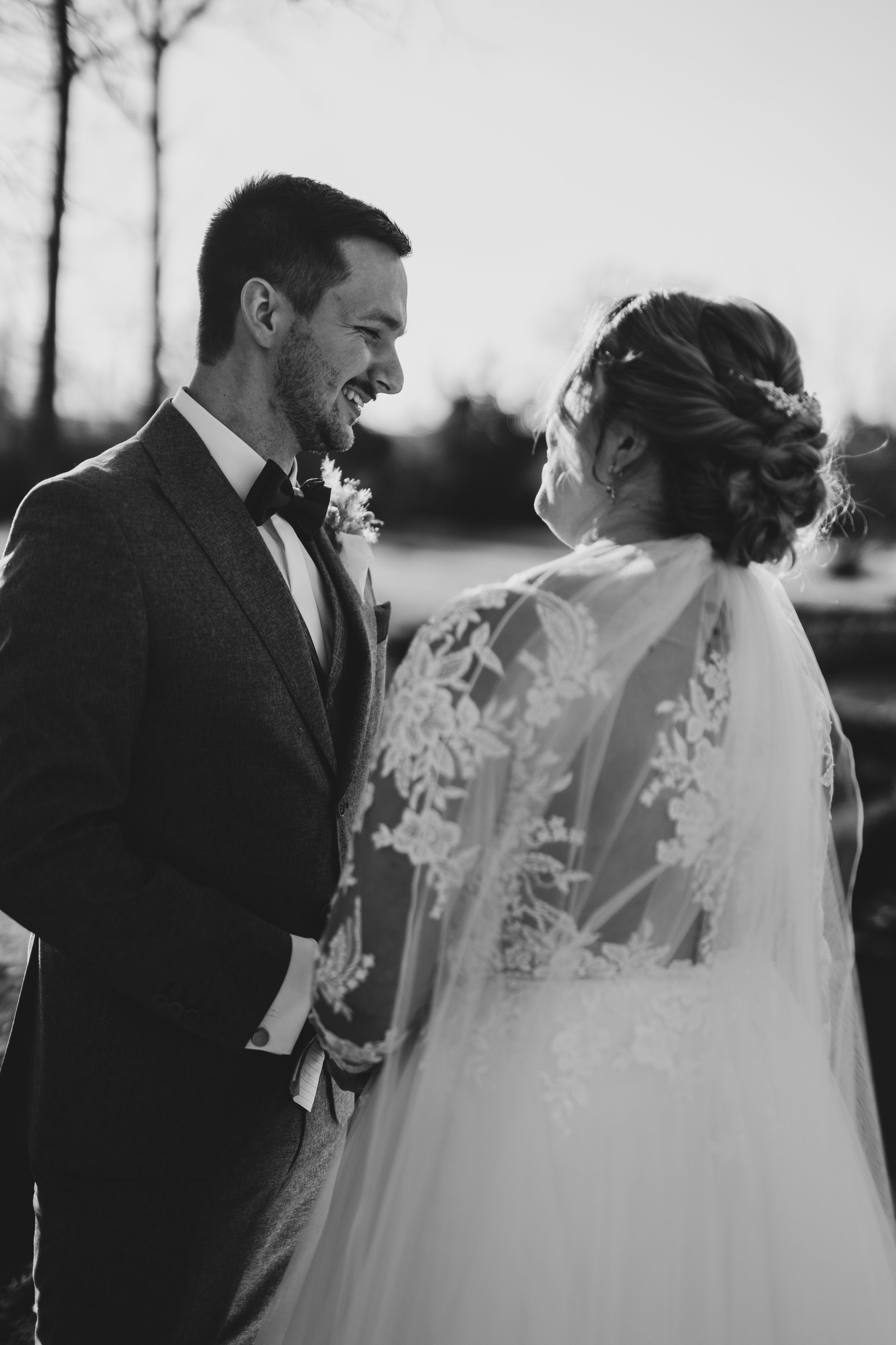 Black and white photo capturing an intimate wedding ceremony moment.
