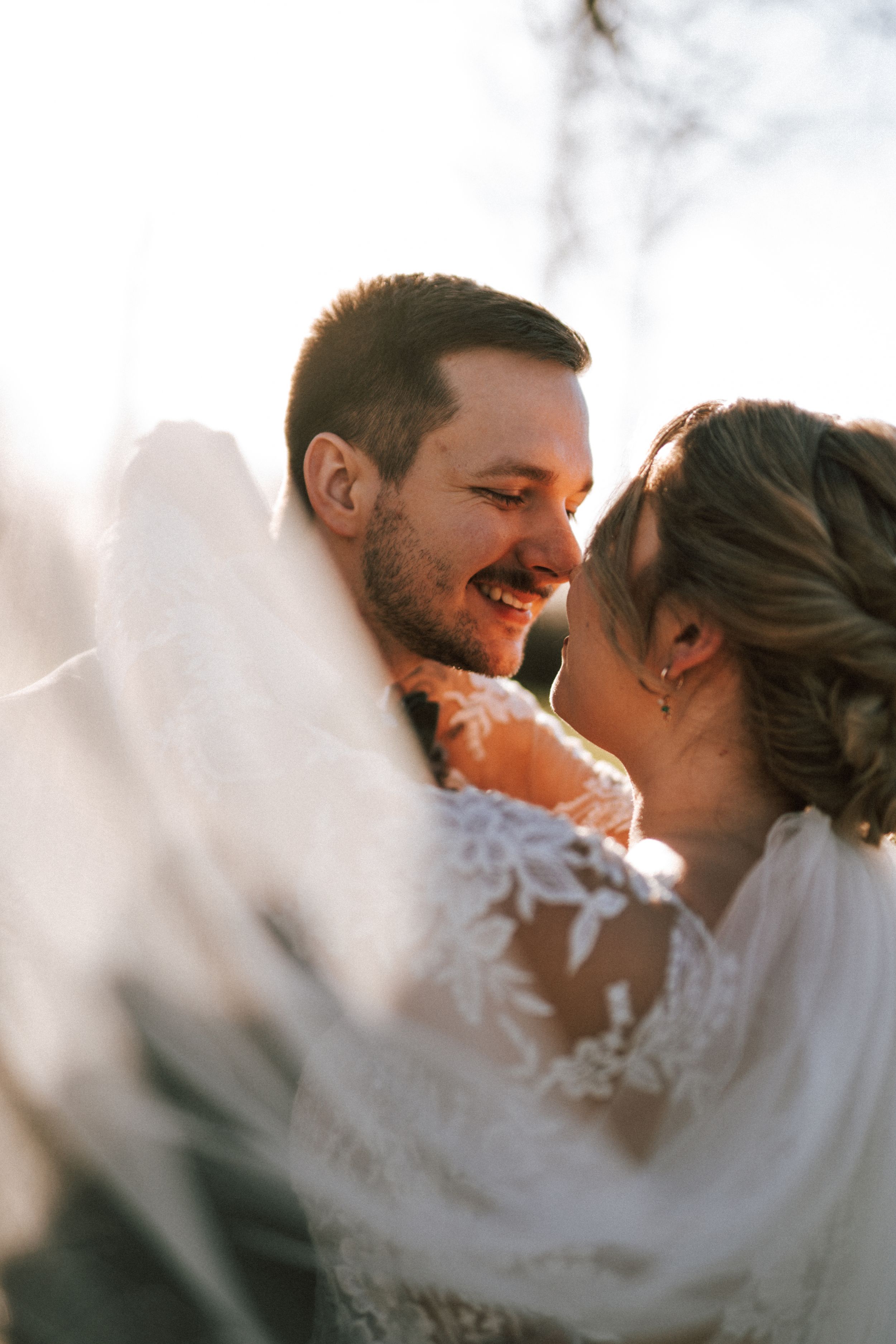 Intimate wedding moment captured in dreamy golden hour light.