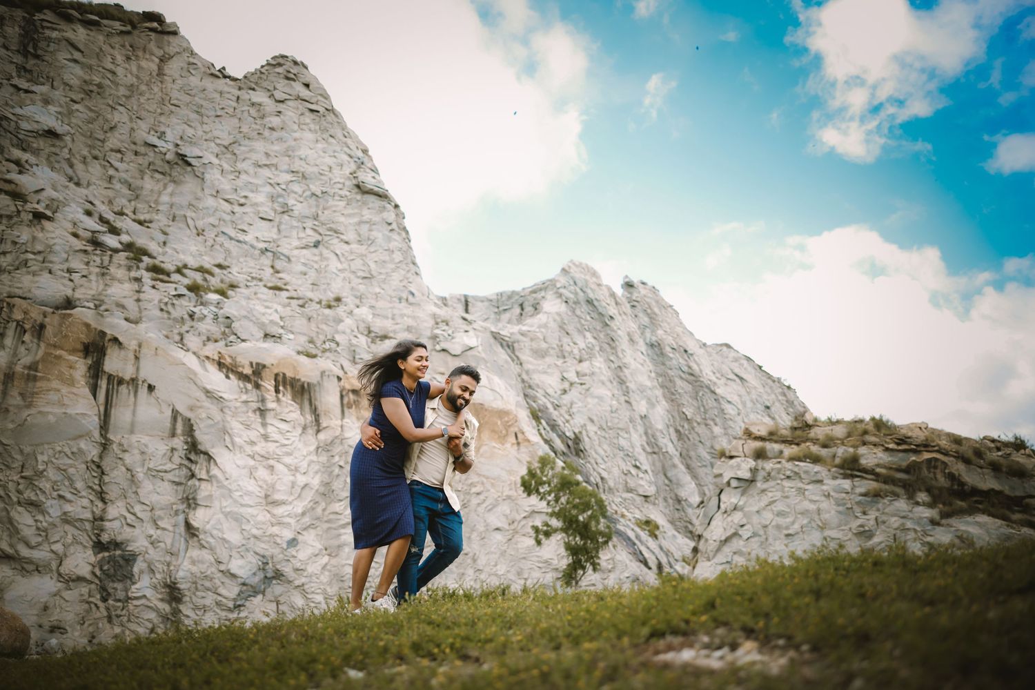 A romantic photoshoot against dramatic white cliffs and blue sky landscape.