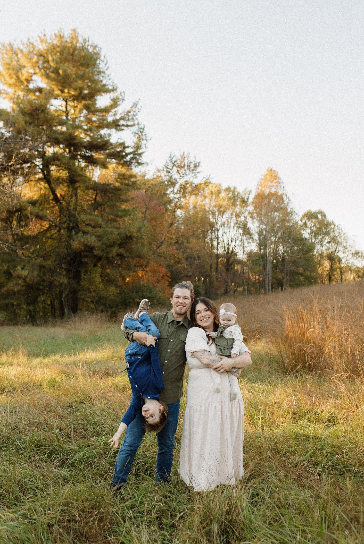 Family sharing joyful moment together in open field during autumn.