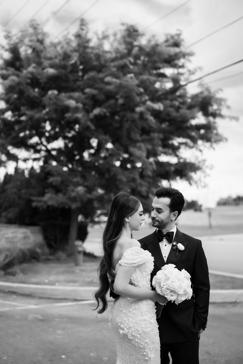 Romantic black and white wedding portraits captured in a suburban setting.
