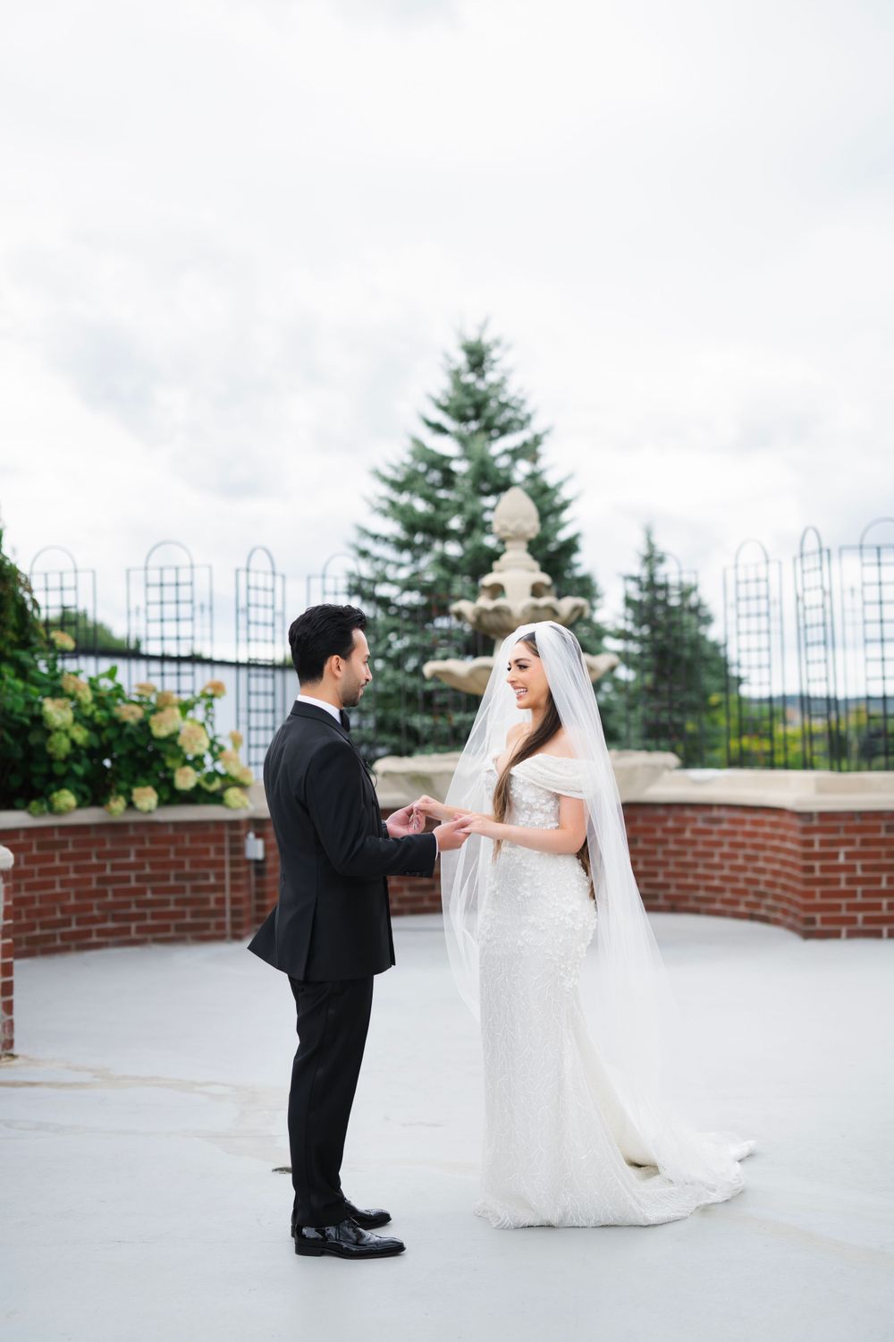 Wedding couple shares intimate first look moment on outdoor terrace.