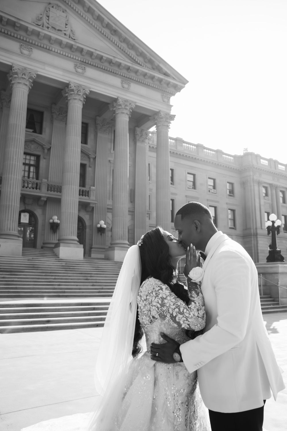 Classic black and white wedding photos taken on grand architecture steps.
