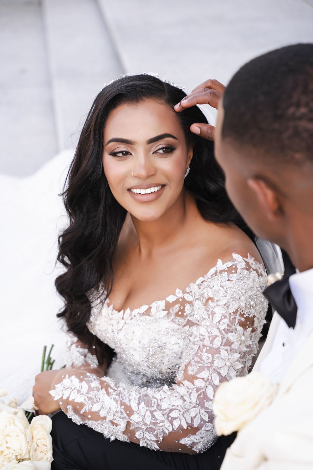 Close-up wedding portraits showing intricate lace details of bridal gown.