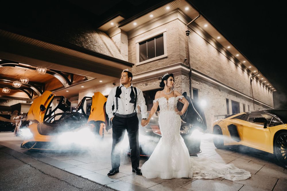 Artistic low-angle wedding photo with dramatic smoke effects and lighting.