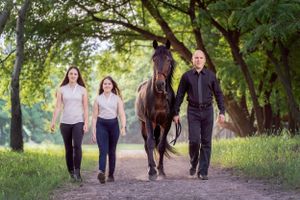Dad and his daughter walking on a nice green path with their beautiful horse during a photoshoot in Sydney Glenorie