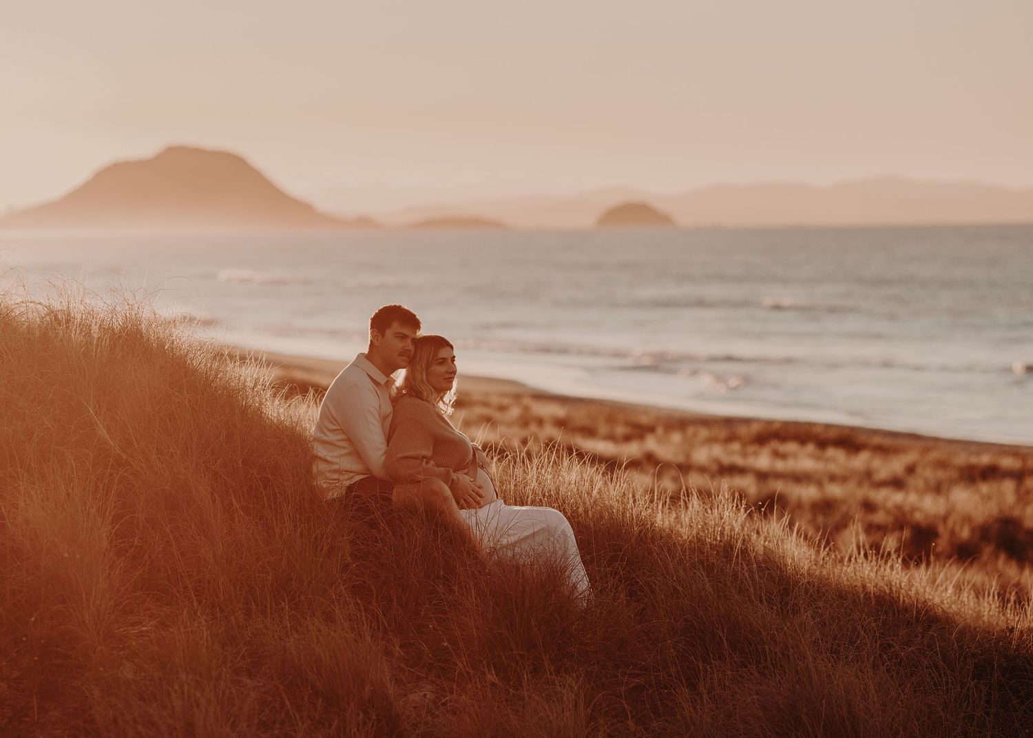 Stunning sunset landscape over rolling hills with warm golden lighting.