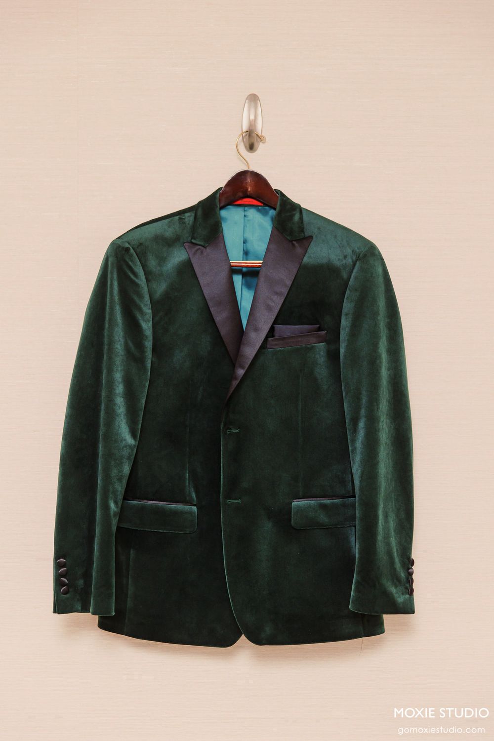 Elegant emerald green velvet tuxedo jacket with black satin lapels displayed from multiple angles.