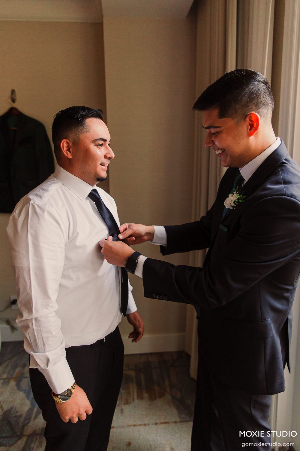 Sequence of photos showing groomsmen helping each other adjust ties and suit details before wedding ceremony.