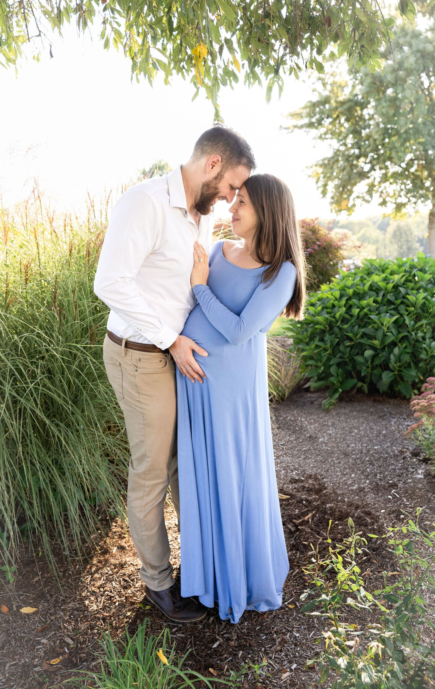 Romantic outdoor couple photos taken against lush garden greenery.