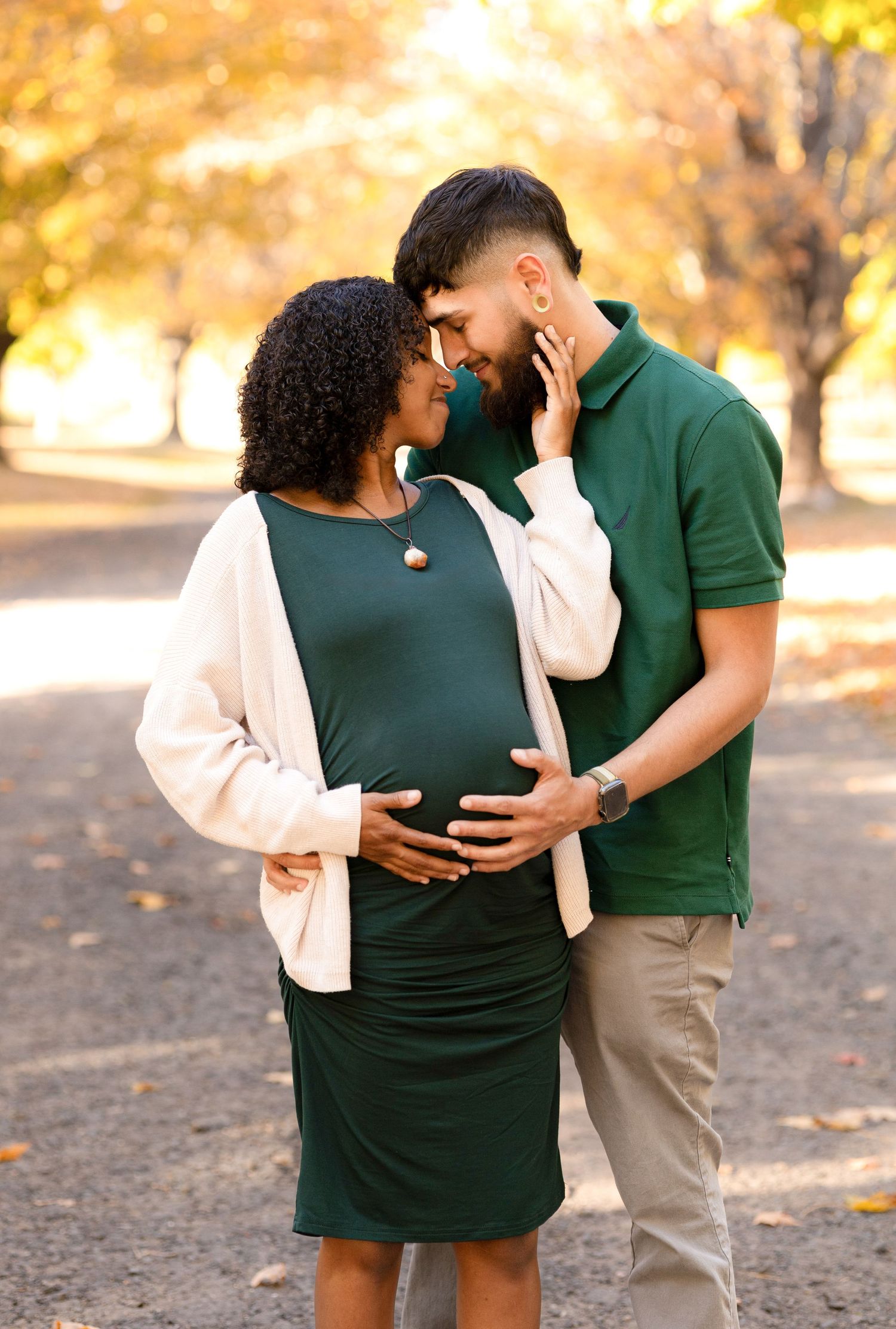 Family shares tender moments together during fall photo session.