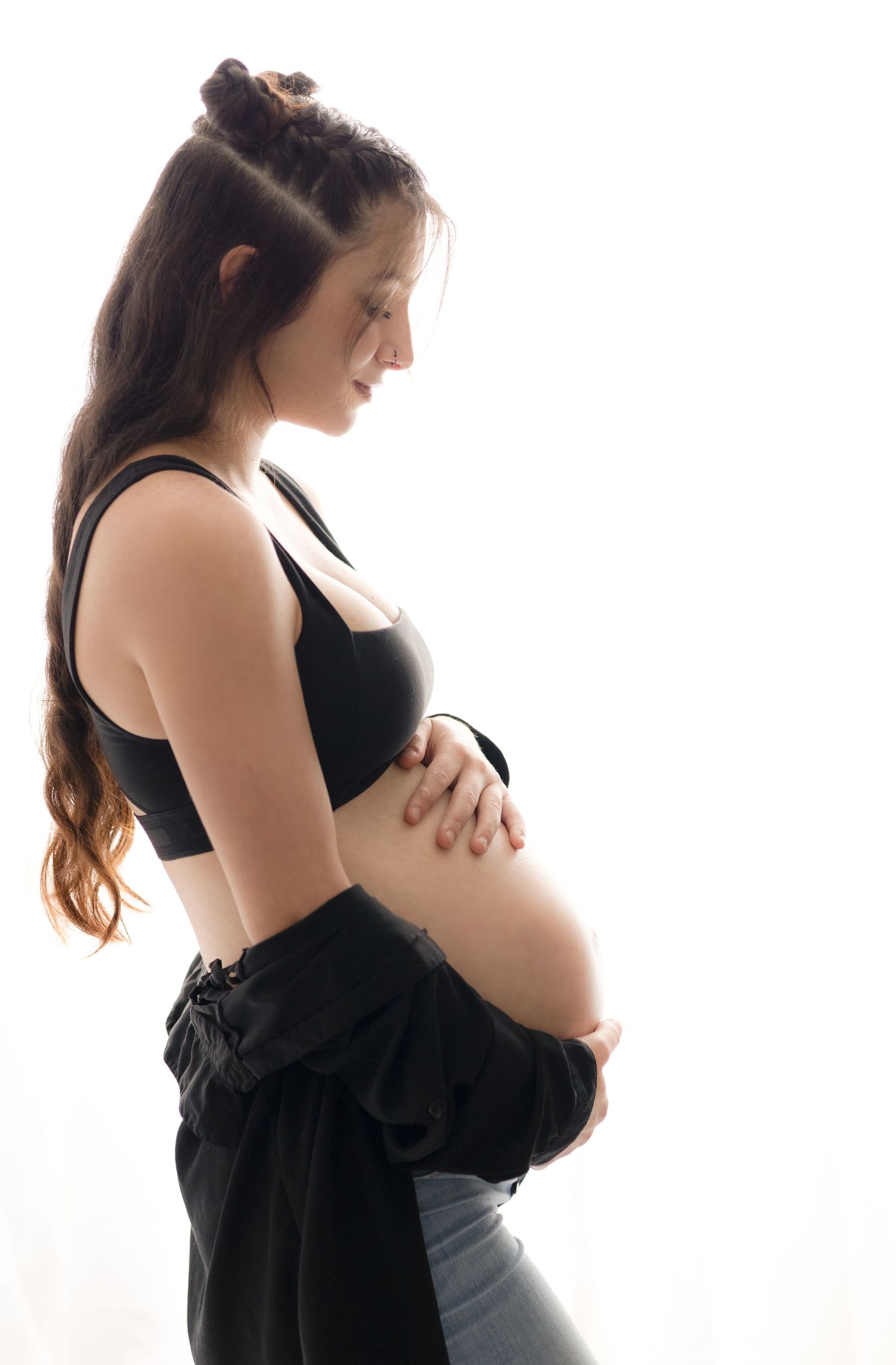 Artistic maternity photoshoot silhouette series against white background.
