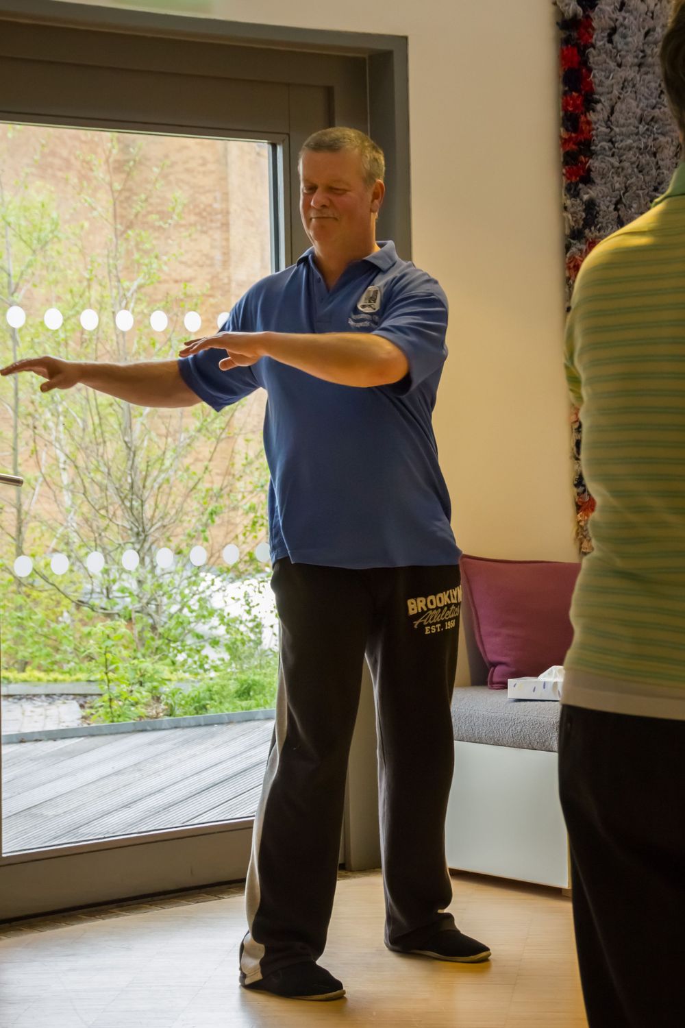 Dance instructor demonstrating proper form and technique during a lesson.