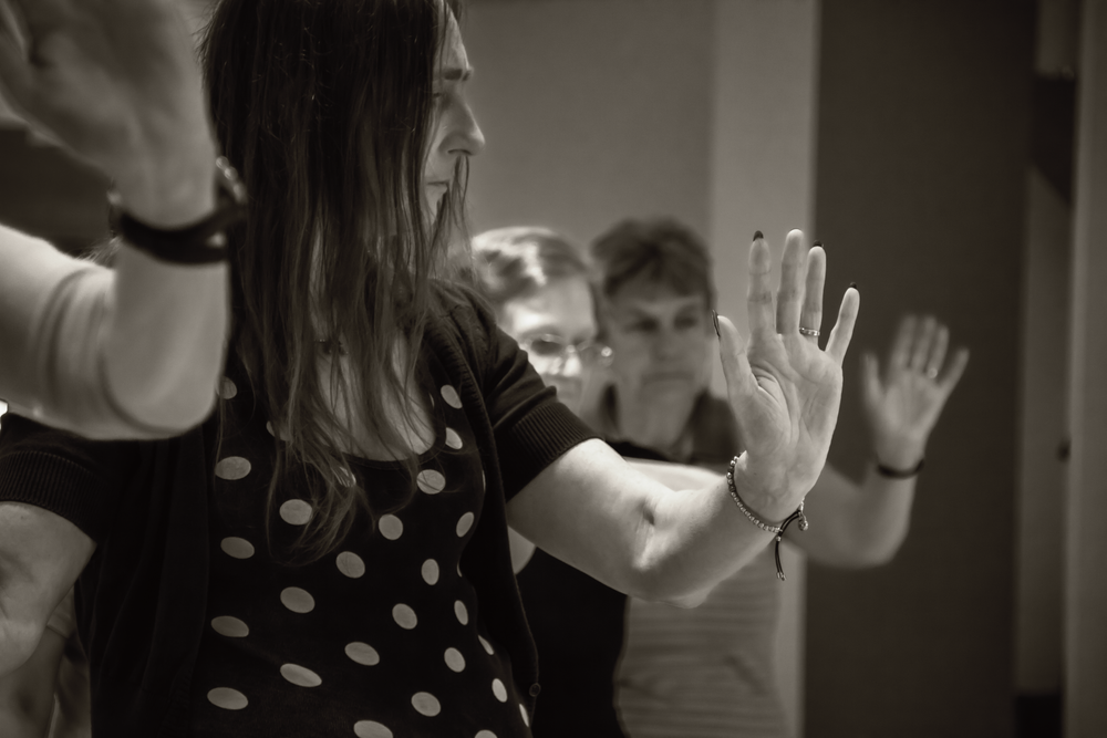 Students practicing hand gestures in a movement class.