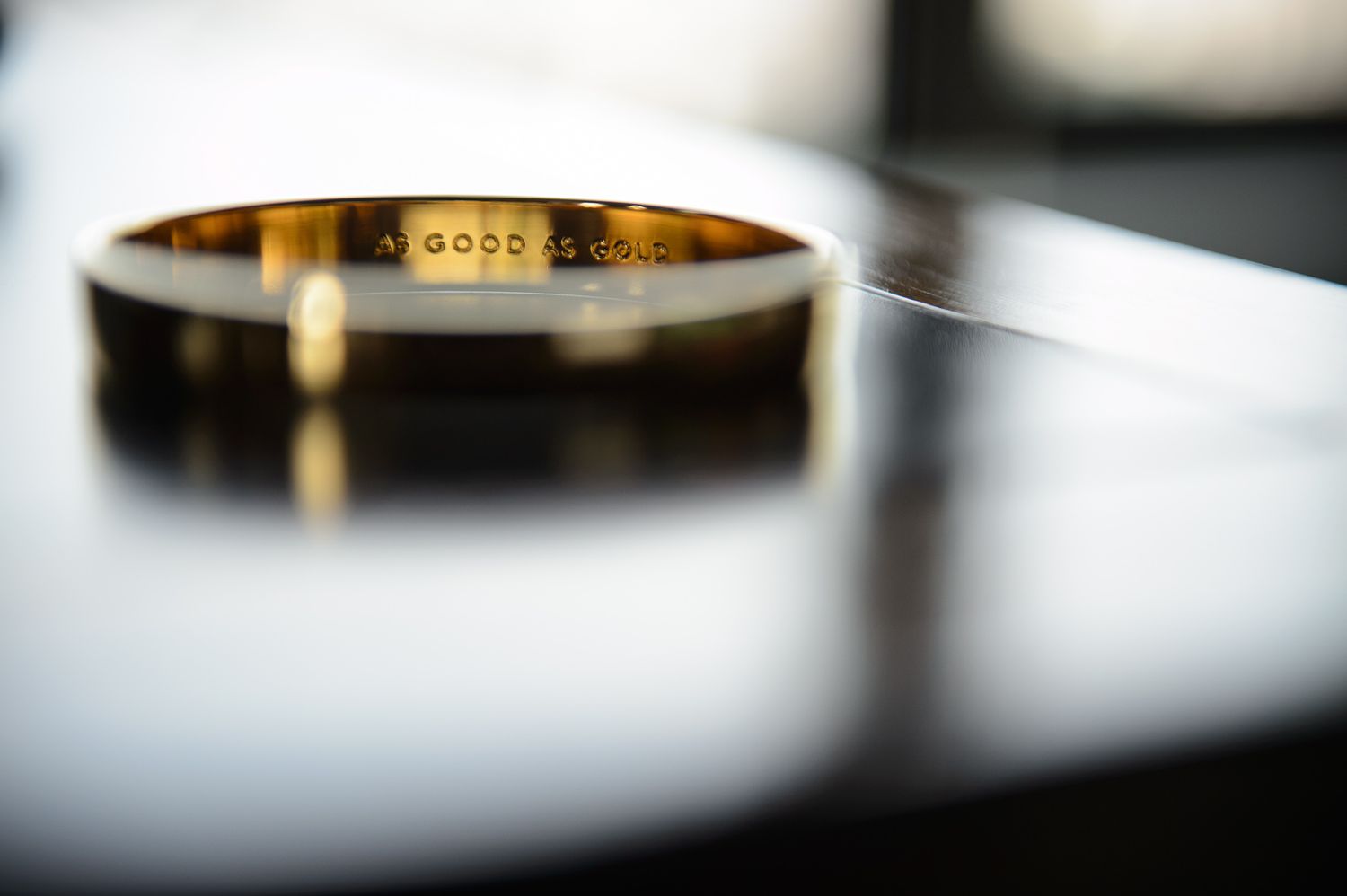 Close-up macro shot of a gold ring with blurred background.