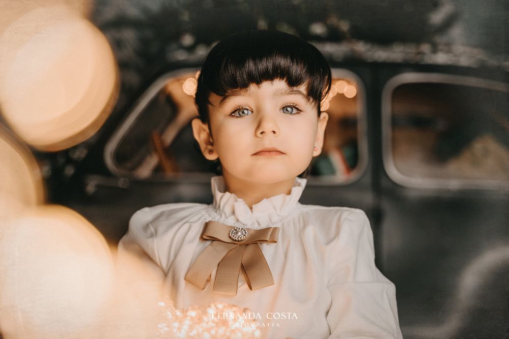 Artistic portrait with soft bokeh lights and vintage styling.