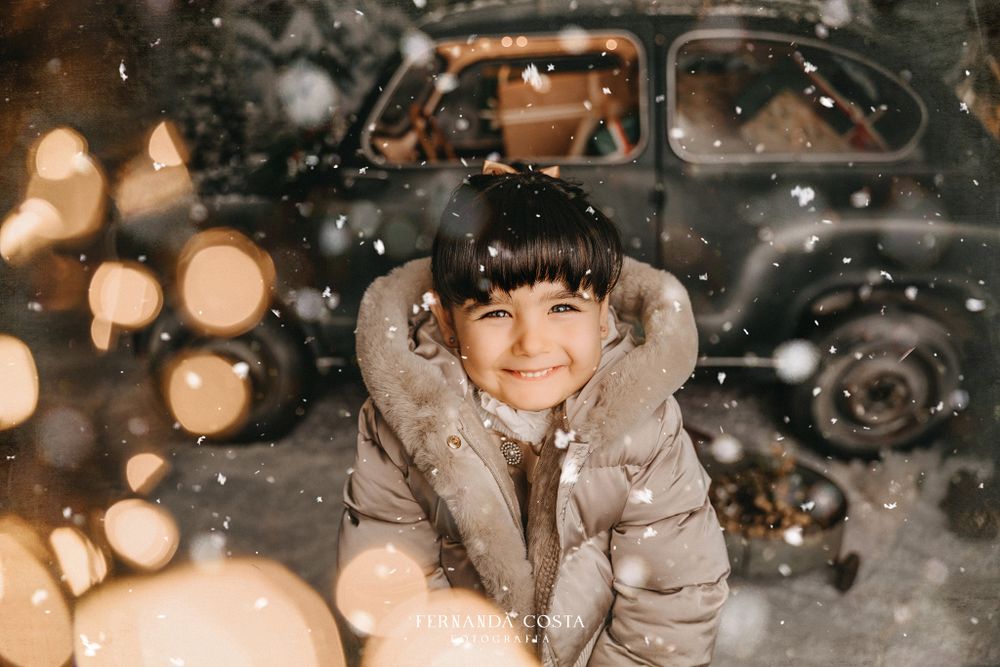 Winter portrait with bokeh lights and falling snow effects.