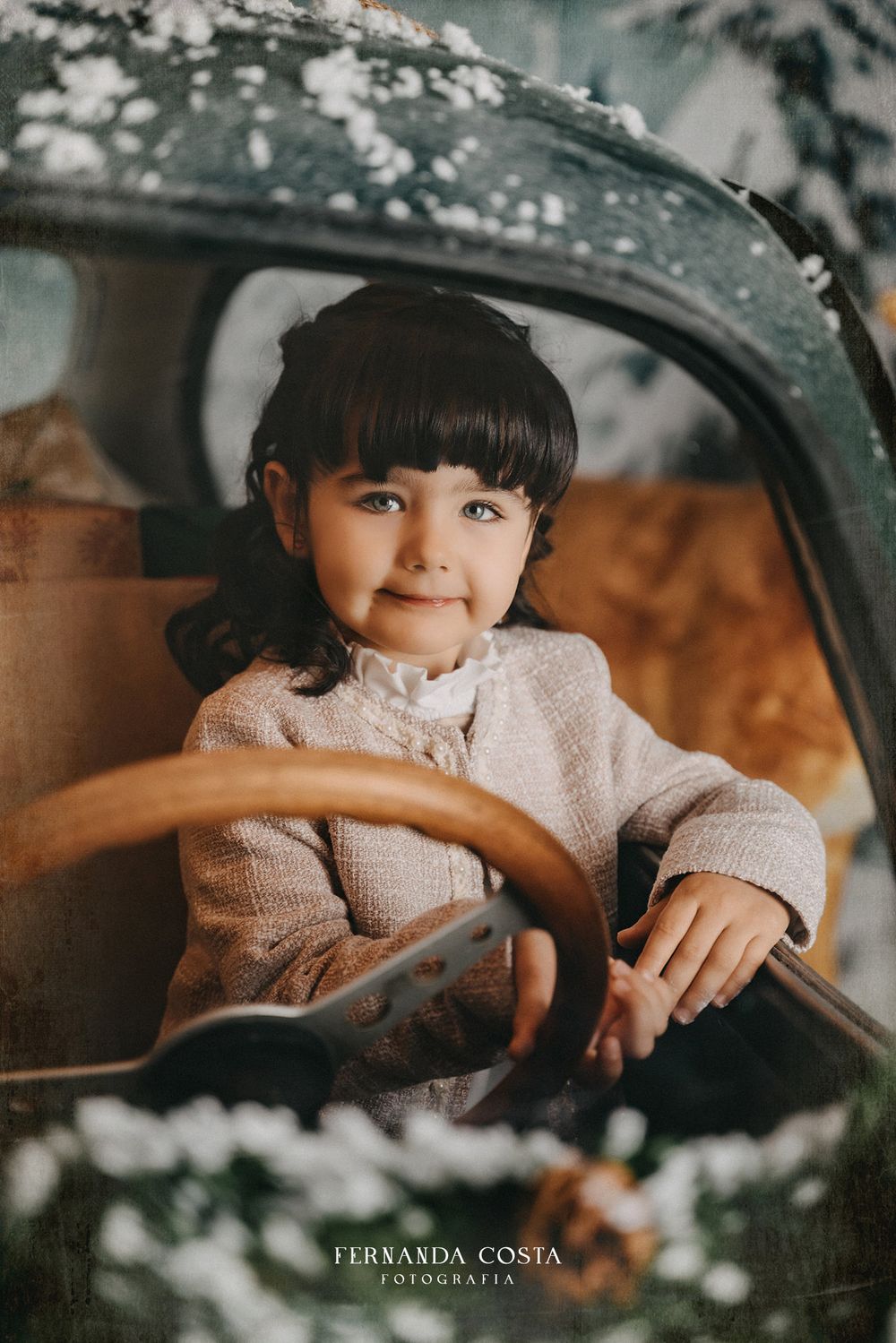 Vintage car photoshoot with soft lighting and snow effects.
