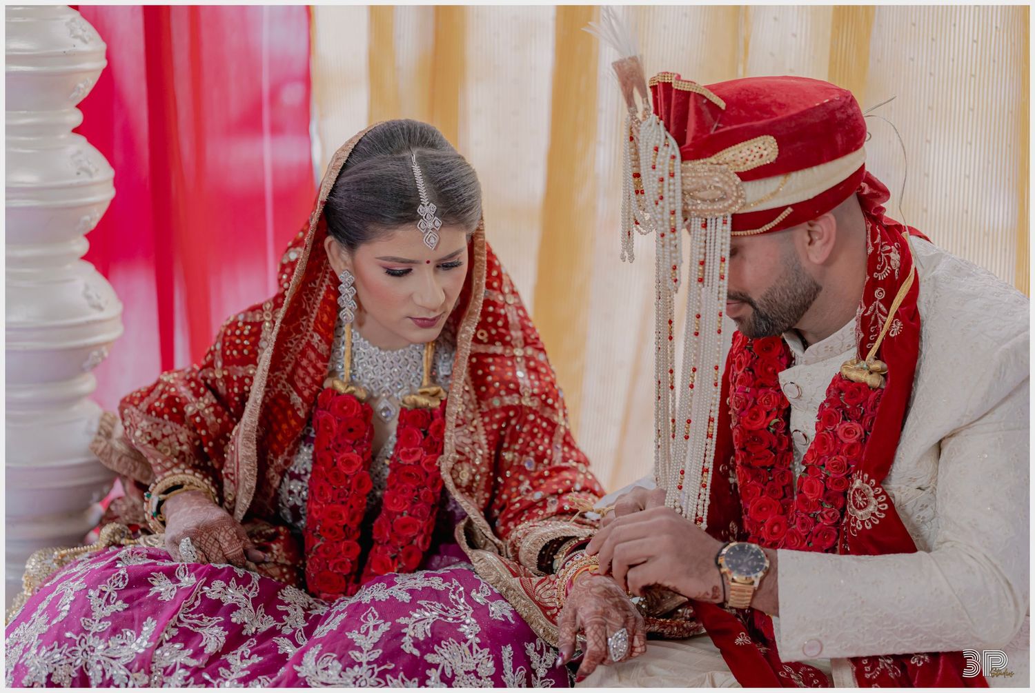 Traditional wedding ceremony showing detailed henna application during marriage ritual.