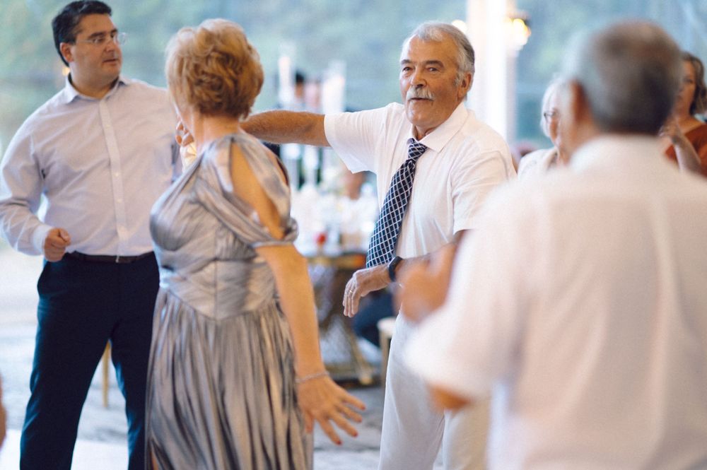 People in formal attire socializing at an indoor event space.