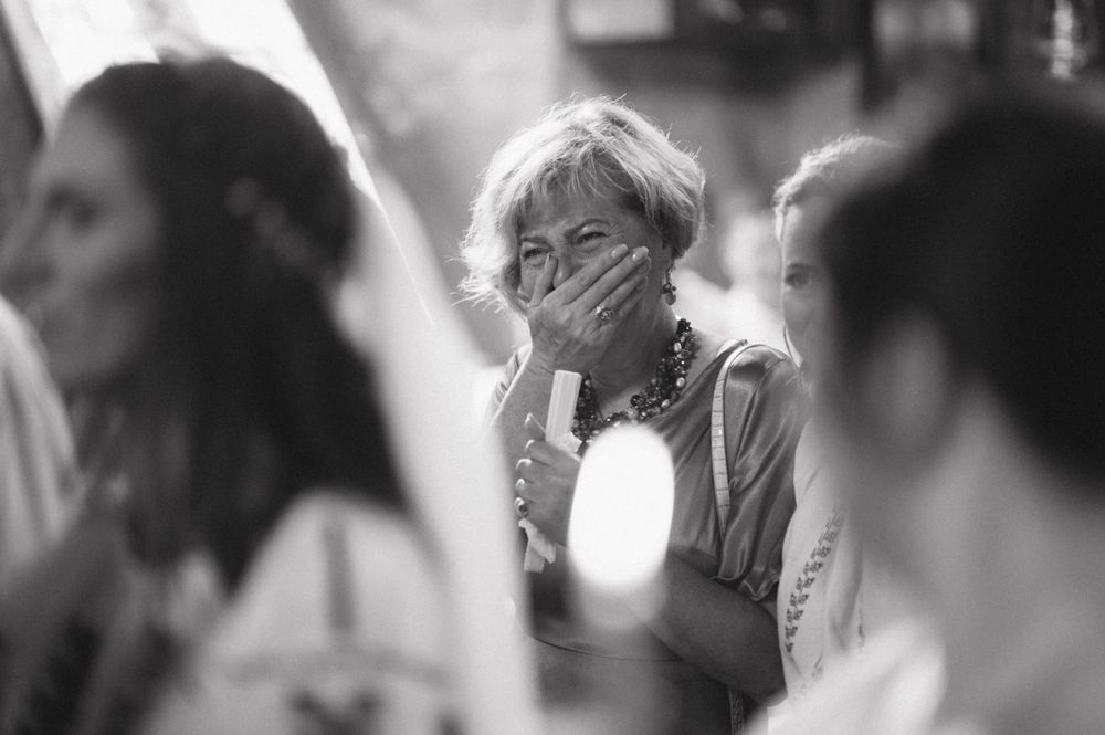Black and white photograph of emotional moment during religious ceremony.