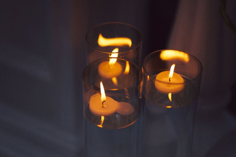 Glowing tea light candles in glass holders creating a warm ambiance.