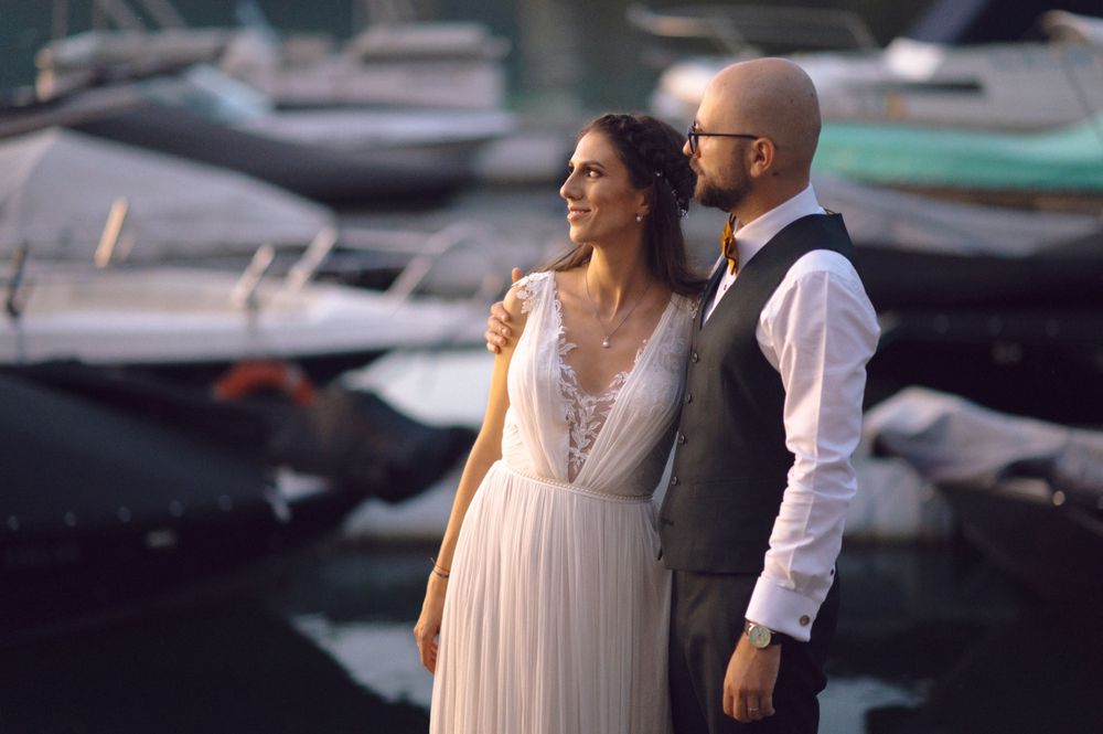 Couple sharing a romantic moment by the marina at dusk.