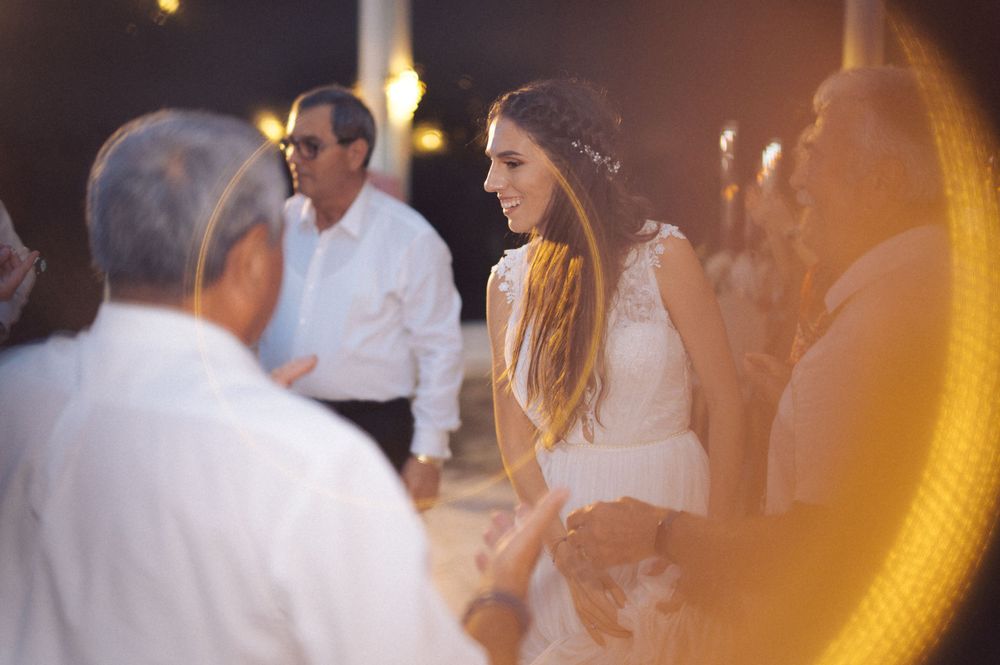 A couple dancing together at a formal event with blue lighting effects in the background.