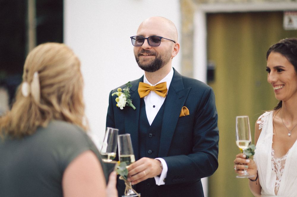 Festive wedding celebration with guests sharing champagne toasts.