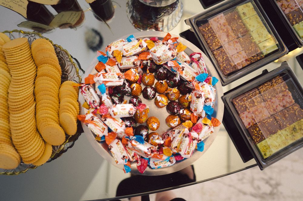 Colorful party snack spread with crackers and decorated cookies on serving platters.