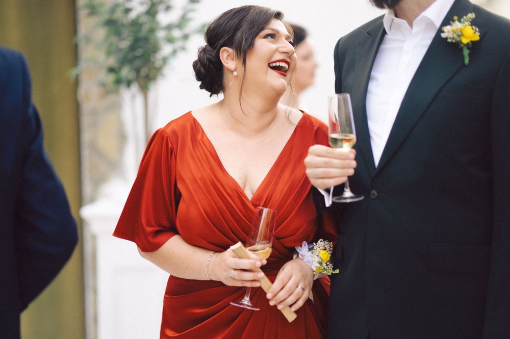 Elegant party scene with guests enjoying champagne and conversation.