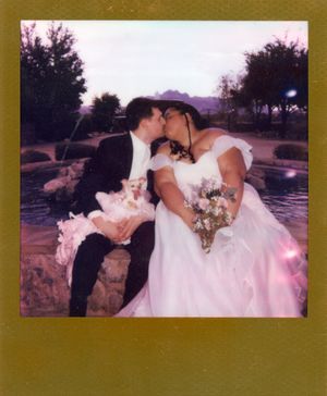 Romantic outdoor wedding photoshoot at sunset with couple in formal attire.