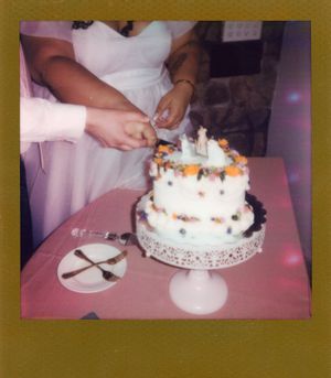 White wedding cakes displayed on stands at a reception.