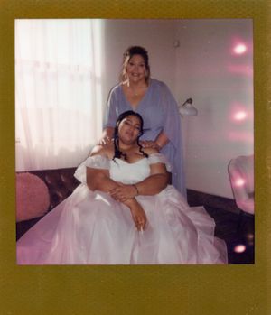 Wedding reception scene with bride in white dress indoors.