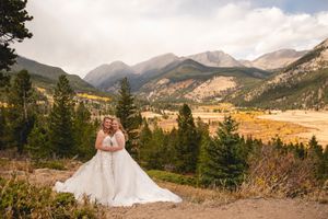 Wedding photography session in front of majestic Rocky Mountain landscape during autumn.