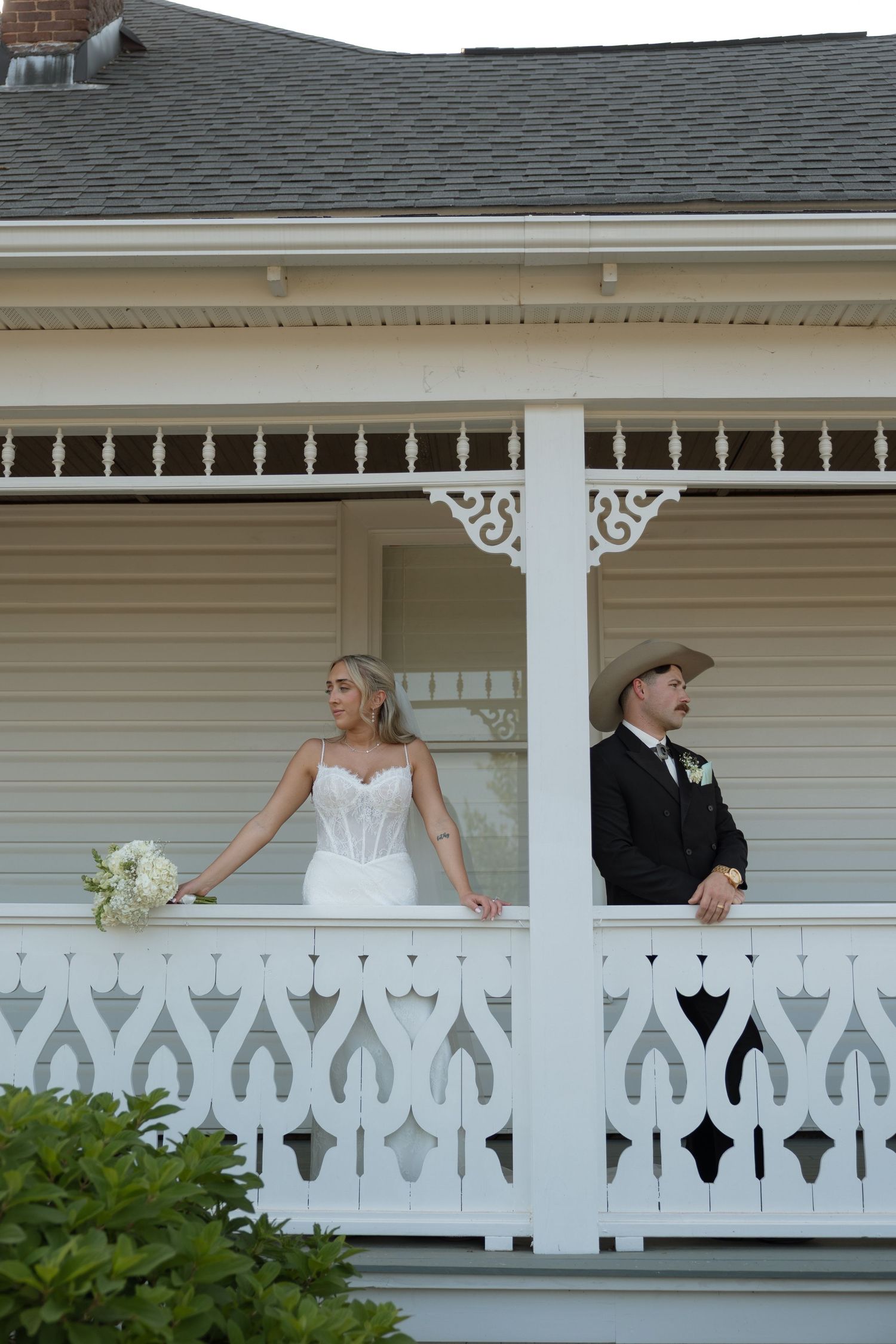 Close-up of wedding couple holding beautiful peach and pink floral bouquet.