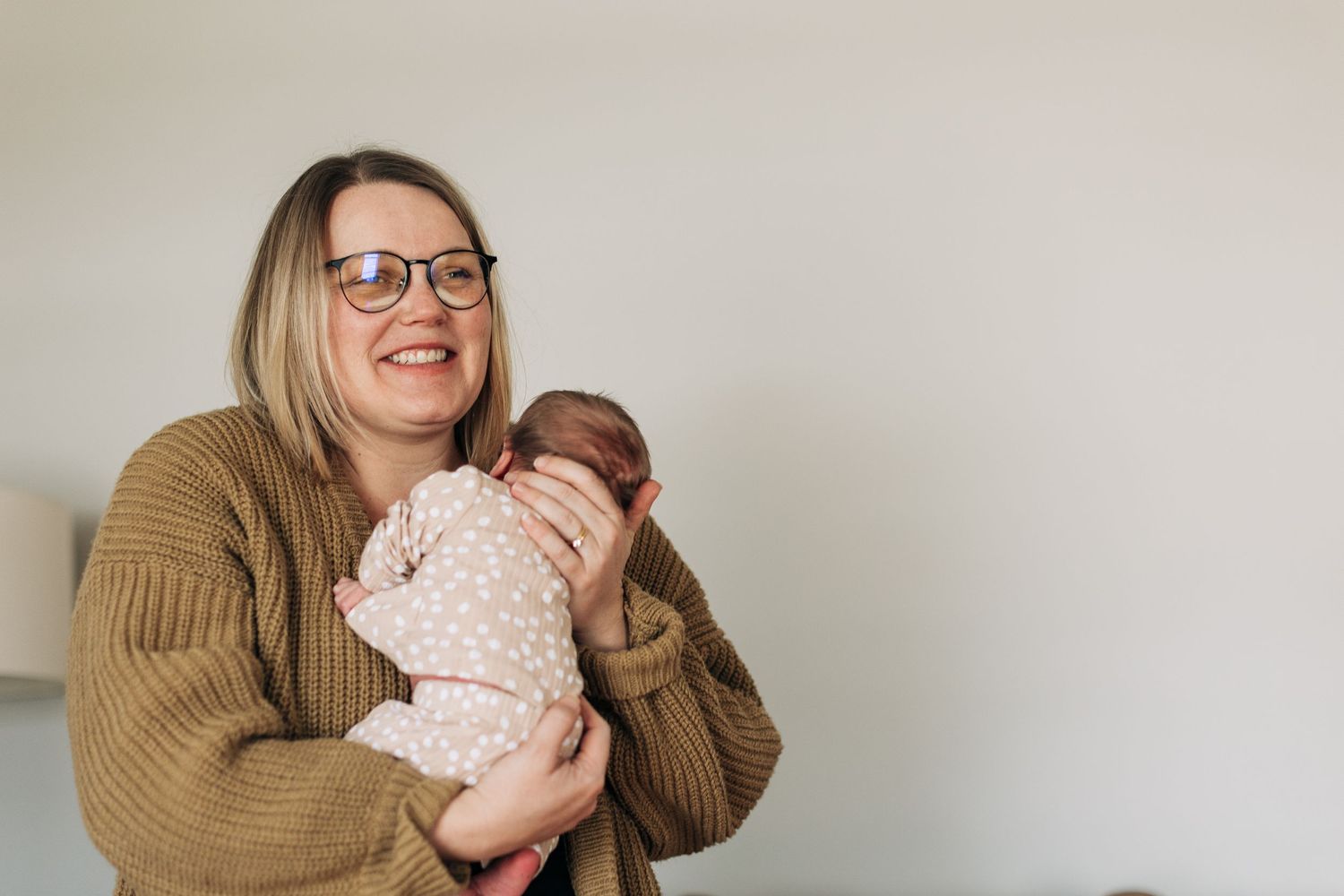 A tender moment shared between a caregiver and infant in a cozy indoor setting.