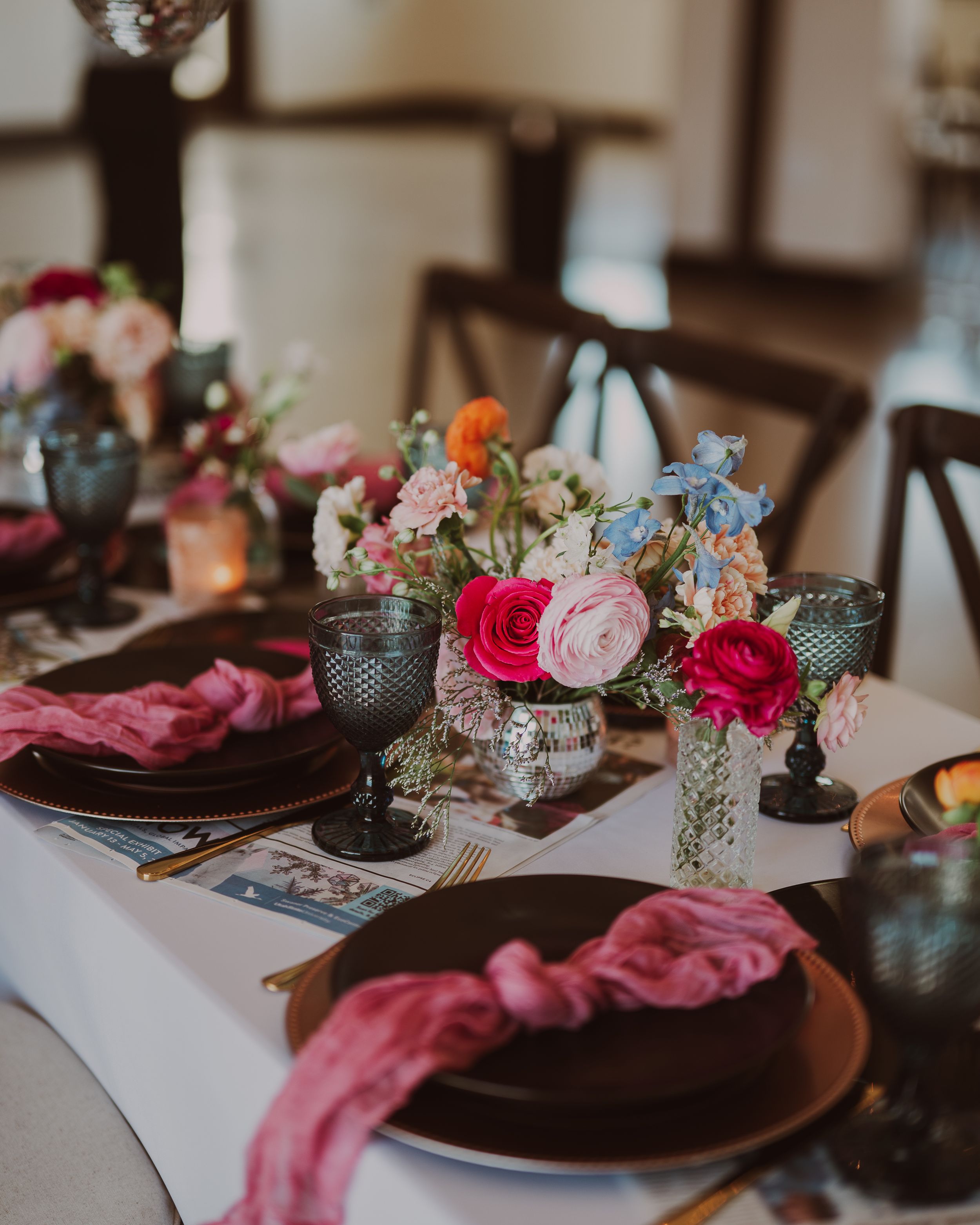 Romantic table decor featuring pink roses, blue hydrangeas, and velvet accents.