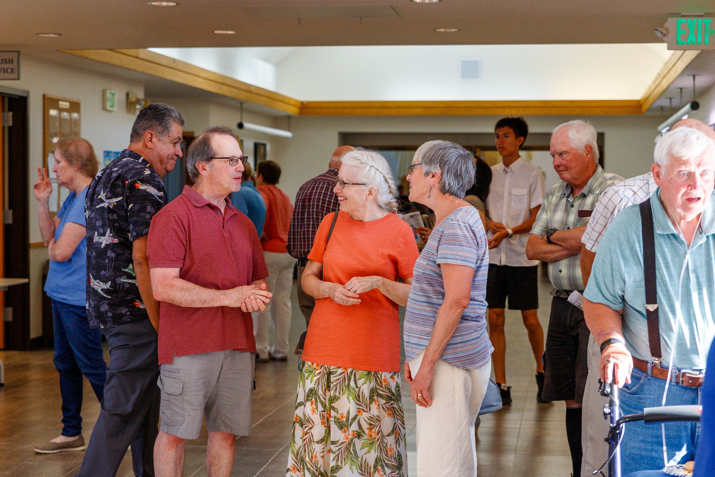 Church members socialize in a hallway during a community gathering.