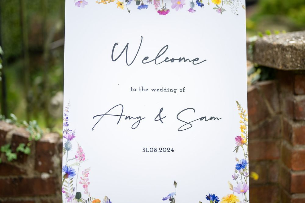 Wedding invitation with delicate floral border design and elegant calligraphy text.