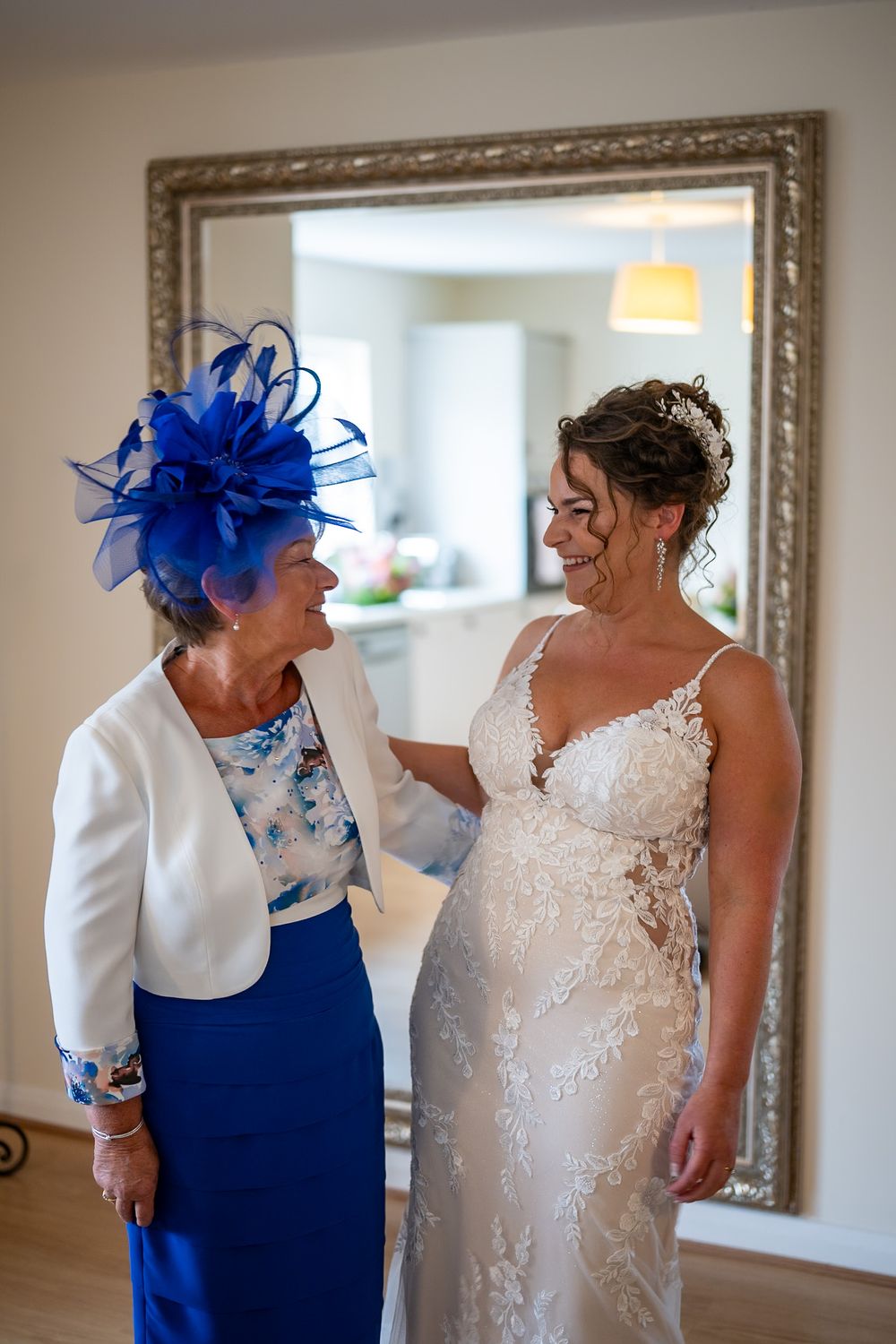 Wedding preparations with elegant white dress and royal blue accessories.
